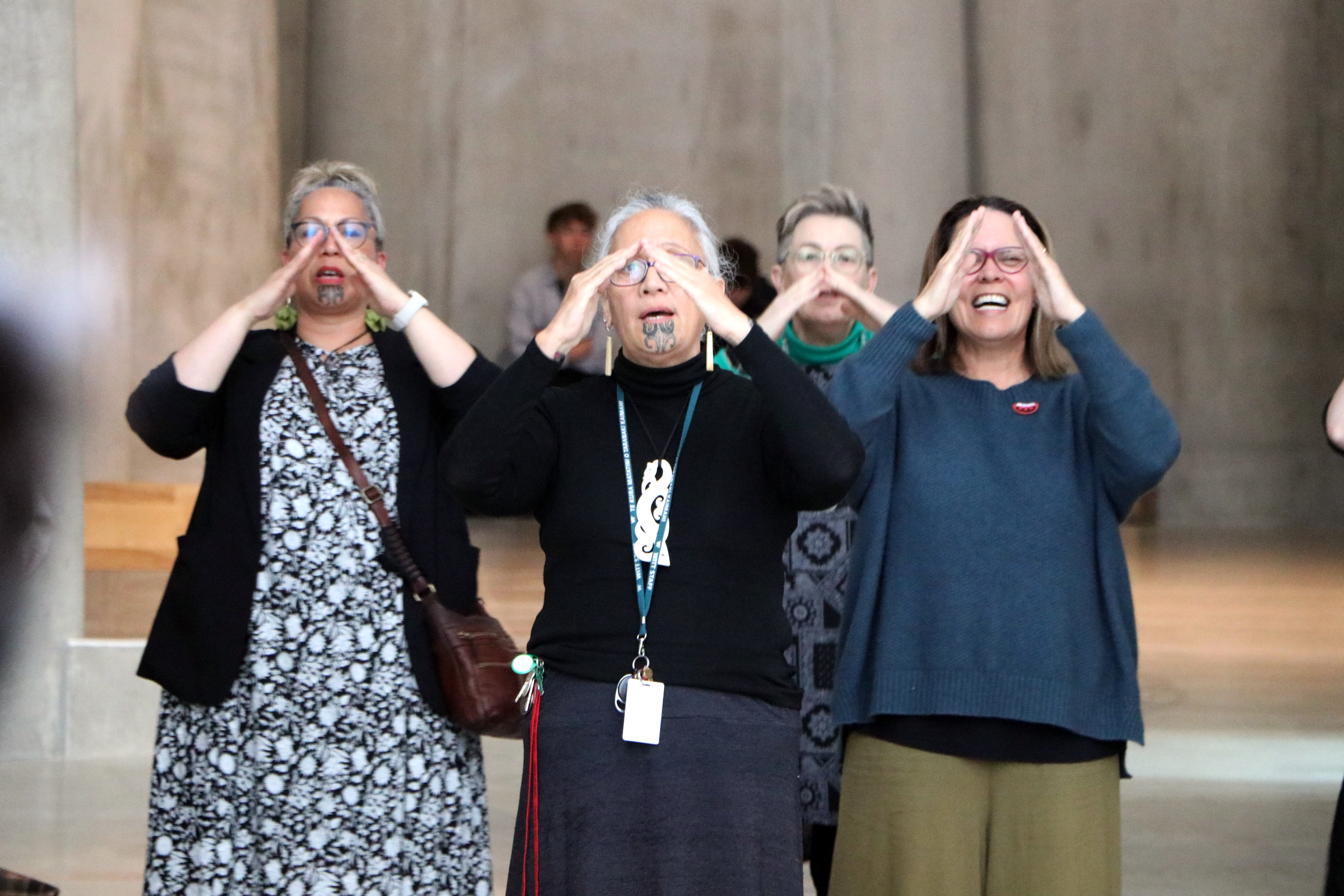A group of people gathered in the Gallery space, singing waiata A group of people gathered in the Gallery space, singing waiata